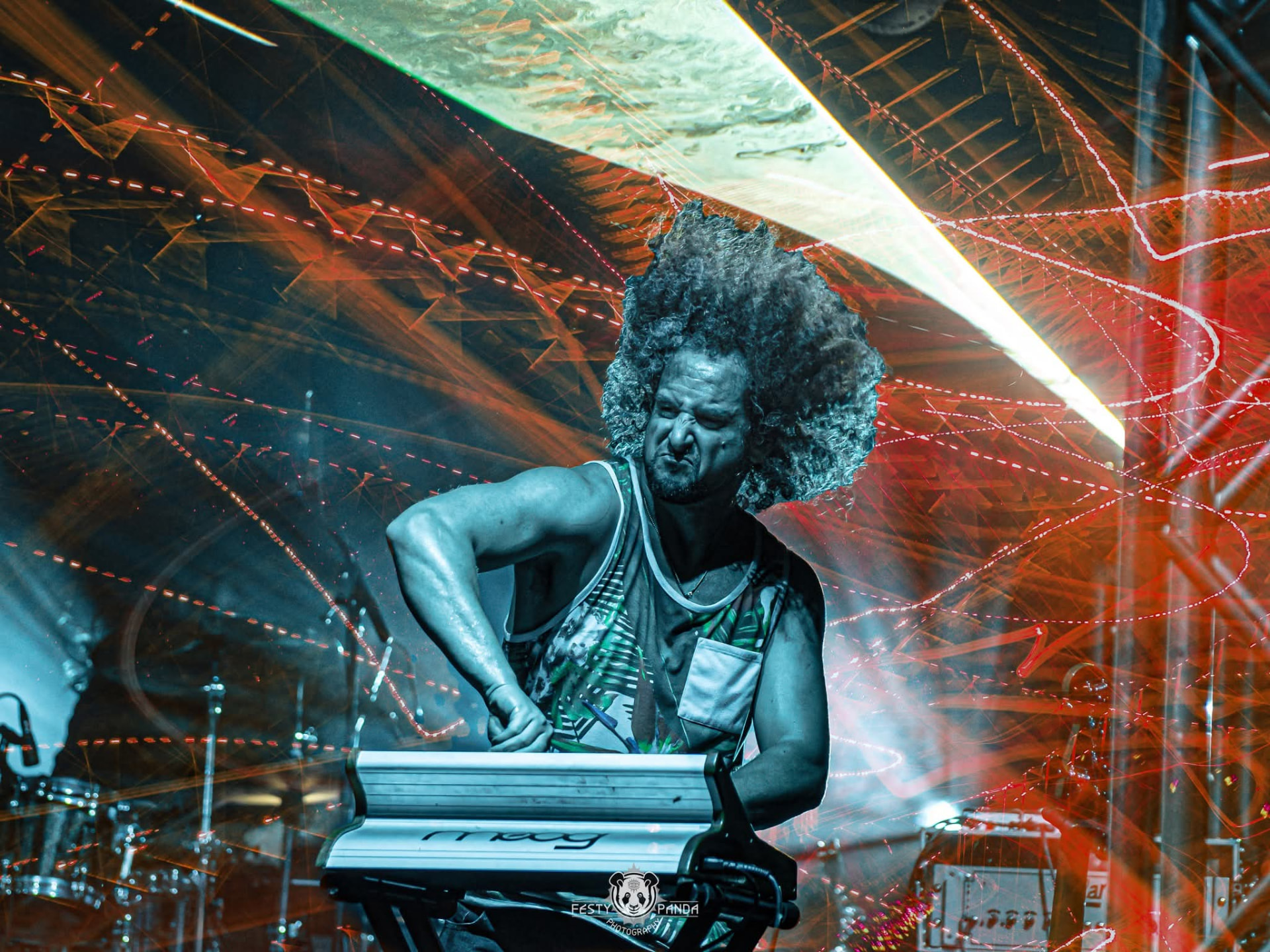 Keyboardist mid-solo under red lasers